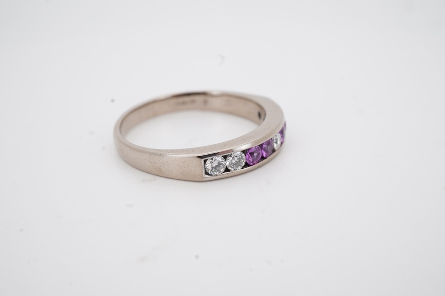 A recent 18ct white gold, four stone pink sapphire and five stone diamond set half hoop ring, size N, gross weight 3.6 grams.